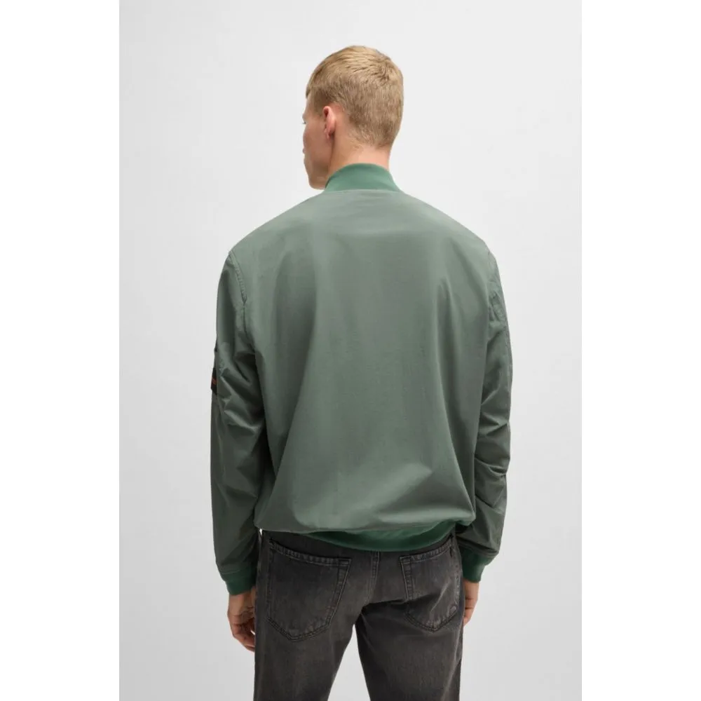 Water-repellent jacket with zipped sleeve pocket